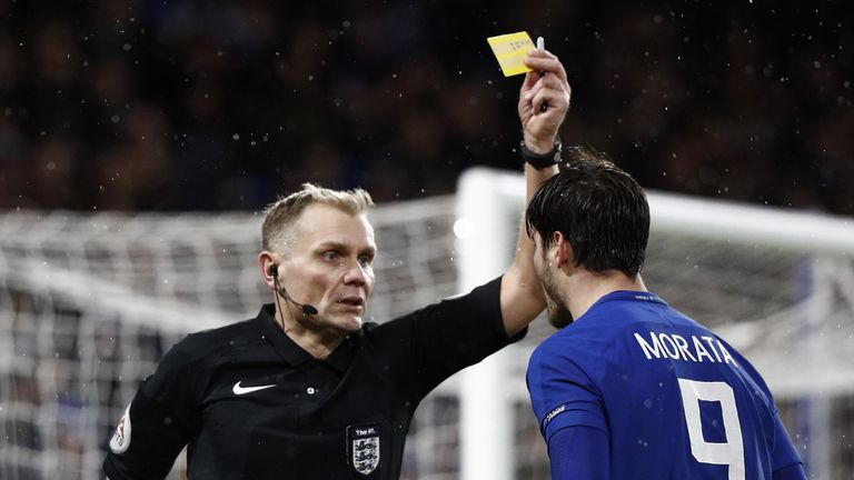 Chelsea's Spanish striker Alvaro Morata (R) gestures to referee Graham Scott (L) as he gets a yellow card during the FA Cup third round replay football mat