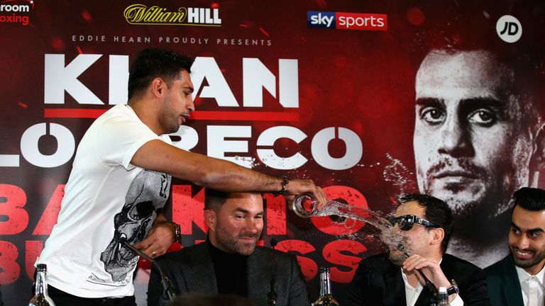 Amir Khan throws a glass of water over Phil Lo Greco during a press conference after comments are made about his personal life