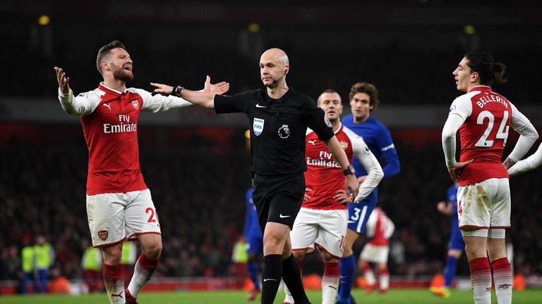 LONDON, ENGLAND - JANUARY 03:  Match Referee Anthony Taylor points to the penalty spot as Shkodran Mustafi of Arsenal reacts during the Premier League matc