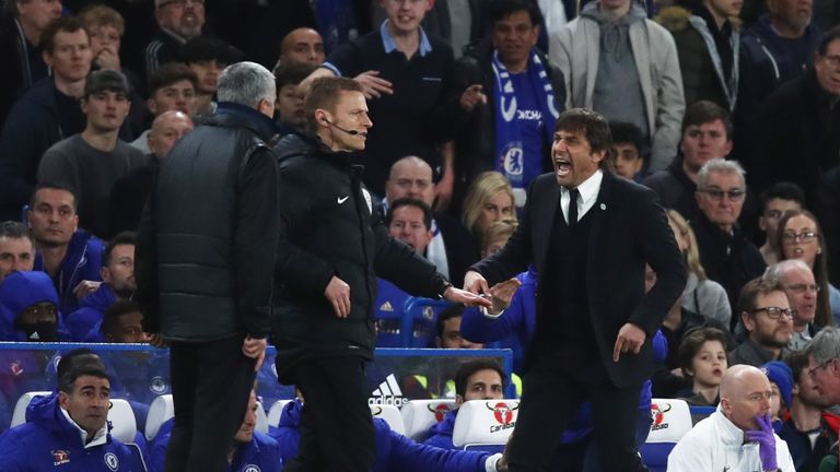 LONDON, ENGLAND - MARCH 13:  Fourth official Mike Jones intervenes as Jose Mourinho manager of Manchester United and Antonio Conte manager of Chelsea clash
