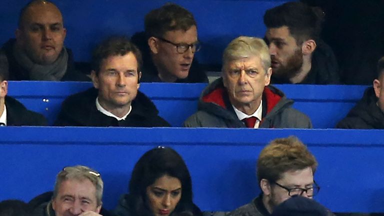 Arsenal's French manager Arsene Wenger (centre right) sits beside Arsenal's former goalkeeper Jens Lehmann in the press box during the English League Cup s