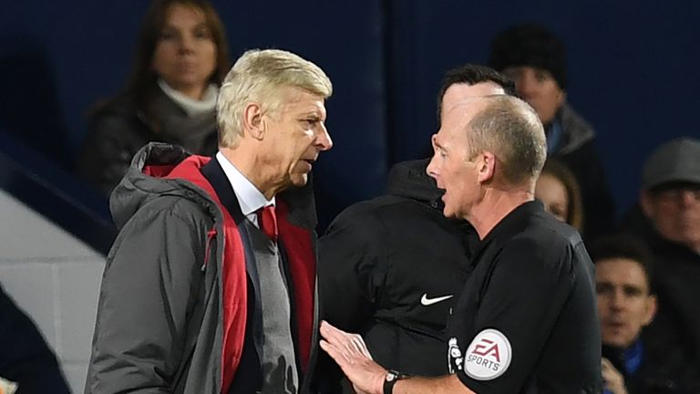 Arsene Wenger speaks with referee Mike Dean during the Premier League football match between West Bromwich Albion and Arsenal at the The Hawthorns