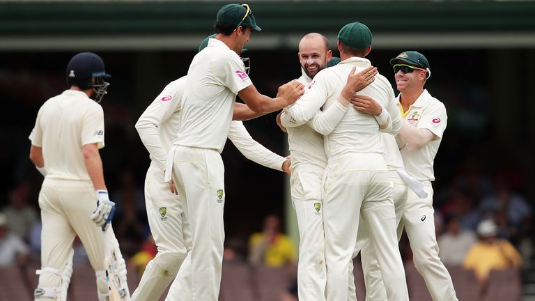 SYDNEY, AUSTRALIA - JANUARY 08:  Nathan Lyon of Australia celebrates with team mates after taking the wicket of Moeen Ali of England during day five  of th