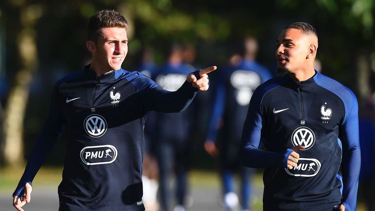 France's defenders Aymeric Laporte and Layvin Kurzawa (R) run during a training session in Clairefontaine-en-Yvelines near Paris on October 3, 2016 ahead o