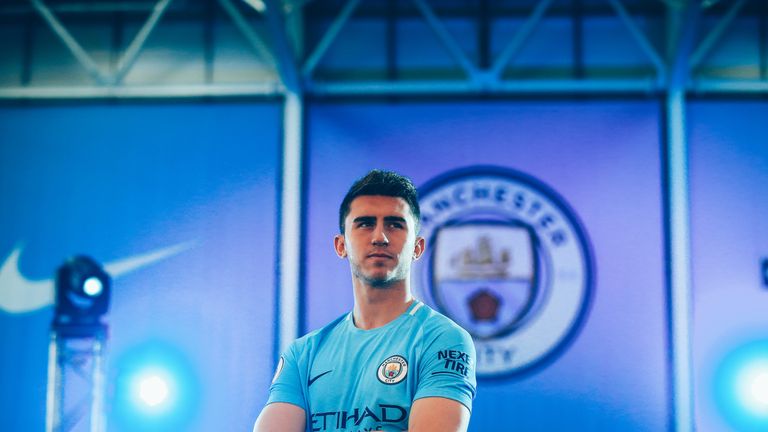 Aymeric Laporte poses during a photoshoot after signing for Manchester City