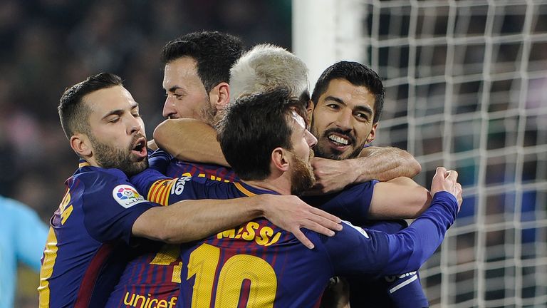 Barcelona's Uruguayan forward Luis Suarez (R) celebrates with teammates after scoring a goal during the Spanish league football match between Real Betis an
