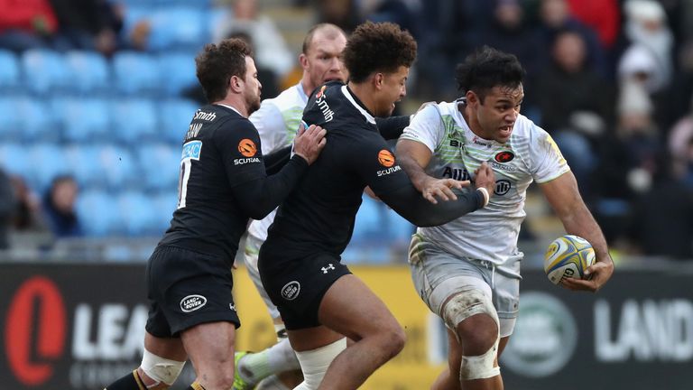 COVENTRY, ENGLAND - JANUARY 07:  Billy Vunipola of Saracens is tackled by Guy Armitage and Danny Cipriani (L) during the Aviva Premiership match between Wa