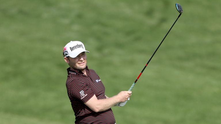 DUBAI, UNITED ARAB EMIRATES - JANUARY 26: Branden Grace of South Africa plays his second shot on the par 5, 10th hole during the second round of the Omega 