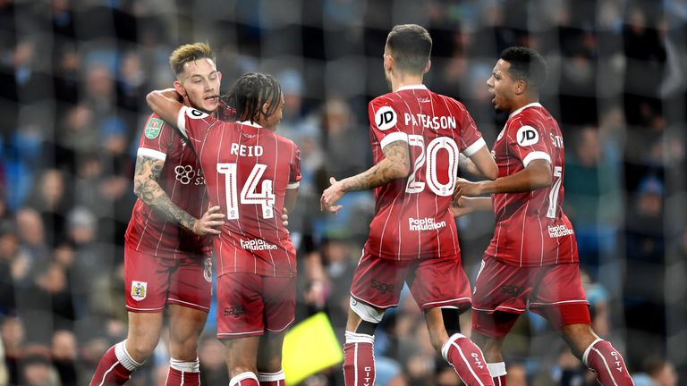 MANCHESTER, ENGLAND - JANUARY 09:  Bobby Reid of Bristol City (14) celebrates as he scores their first goal from the penalty spot with team mates during th