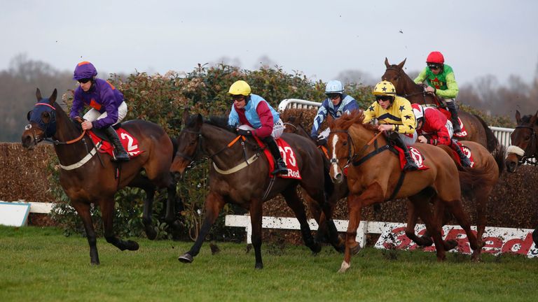 Buywise and Leighton Aspell (red cap) trail the leaders over an early fence before going on to win The 32Red Veterans' Handicap Steeple Chase Race run duri