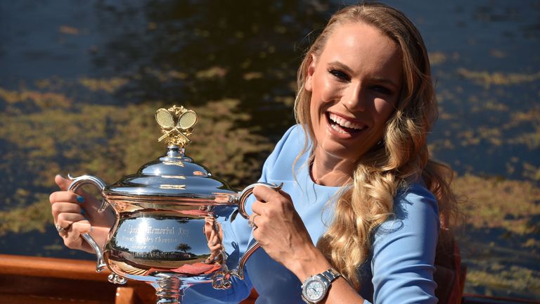 Denmark's Caroline Wozniacki arrives in a gondola with the winner's trophy for a photocall at the Royal Botanical Gardens in Melbourne