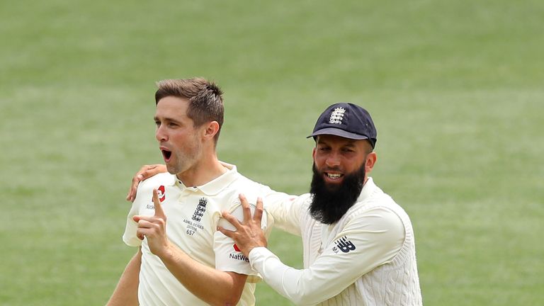 ADELAIDE, AUSTRALIA - DECEMBER 05:  Chris Woakes of England celebrates with team mate Moeen Ali after taking the wicket of Tim Paine of Australia during da