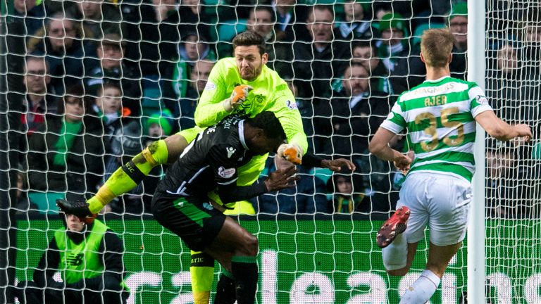 Celtic goalkeeper Craig Gordon comes out to punch a ball and ends up suffering an injury