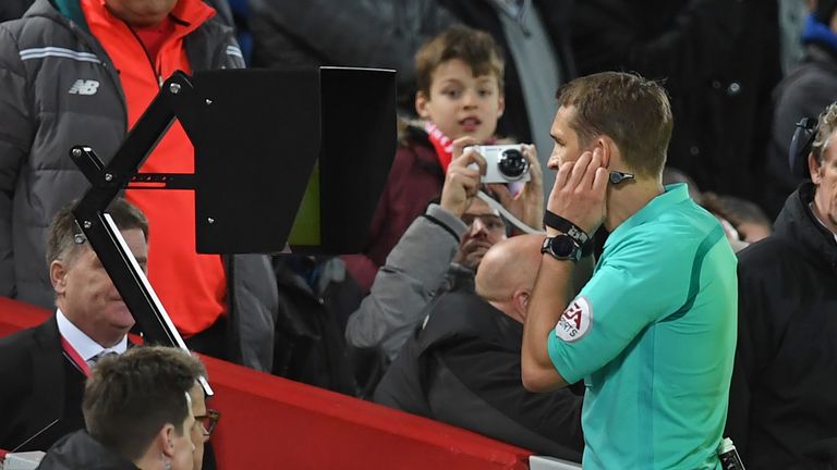 Referee Craig Pawson looks at the pitch-side screen after speaking to the VAR (Video Assistant Referee) before giving Liverpool a penalty
