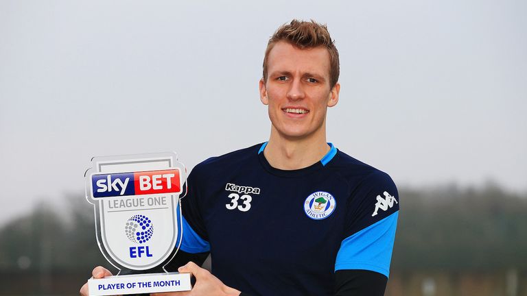 Dan Burn of Wigan Athletic is presented with the Sky Bet Player of the Month award
