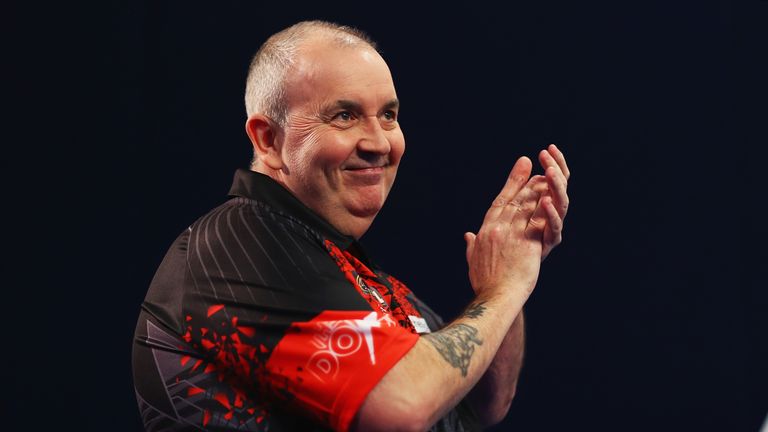 Phil Taylor of England walks onto the stage prior to the second round match against Justin Pipe