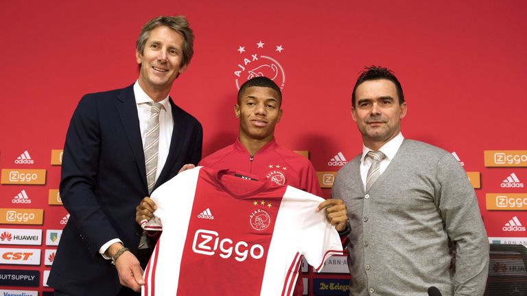 David Neres poses with Ajax Amsterdam football club's marketing directors Edwin van der Sar (L) and Marc Overmars (R)
