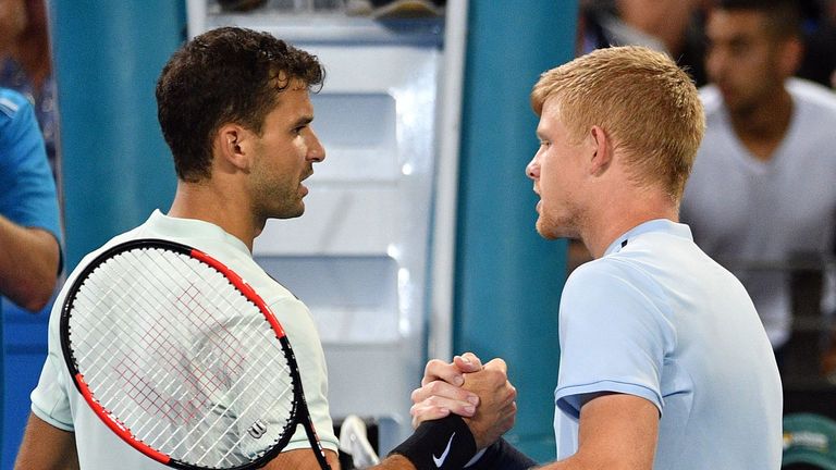 Grigor Dimitrov of Bulgaria shakes hand with Kyle Edmund of Britain (R) after their men's singles quarter-final match at the Brisbane International tennis 