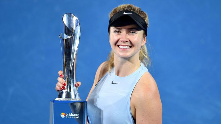Elina Svitolina of Ukraine holds up the winner's trophy after beating Aliaksandra Sasnovich of Belarus in the women's singles final match of the Brisbane