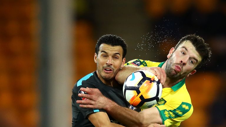 Grant Hanley of Norwich City is challenged by Pedro of Chelsea during The Emirates FA Cup Third Round match at Carrow Road 