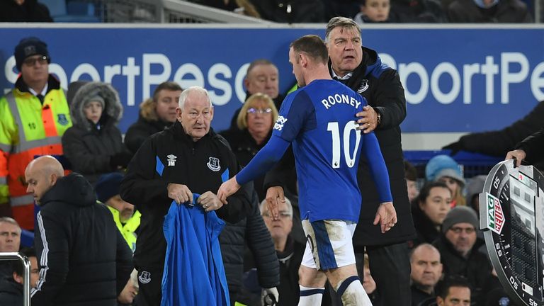 Everton's English striker Wayne Rooney (L) walks past Everton's English manager Sam Allardyce  as he leaves the field during the English Premier League foo