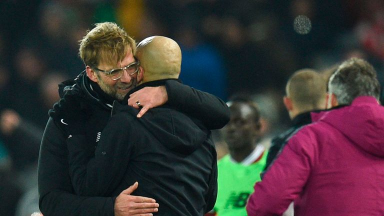 Liverpool's German manager Jurgen Klopp (L) embraces Manchester City's Spanish manager Pep Guardiola (R) at the end of the English Premier League football 