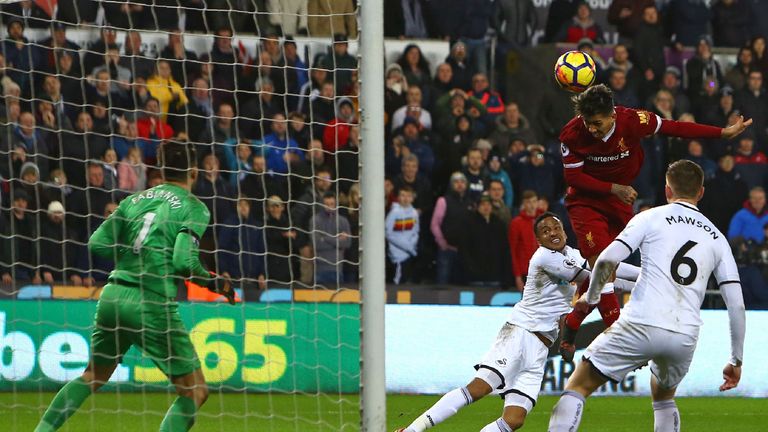 Liverpool's Brazilian midfielder Roberto Firmino (2nd R) jumps to head the ball against the post in the final minutes of the English Premier League footbal