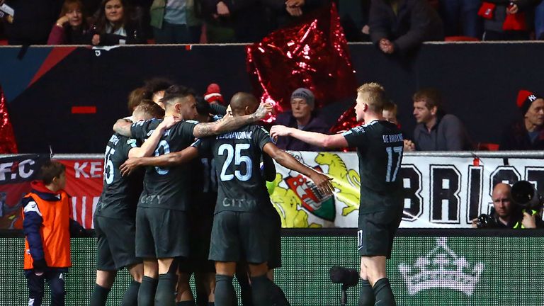 Manchester City players celebrate their opening goal scored by Leroy Sane during the Carabao Cup semi-final, second leg football match at Bristol City