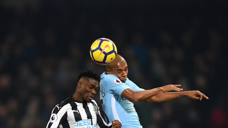 Christian Atsu of Newcastle United and Fernandinho of Manchester City battle for the ball during the Premier League match