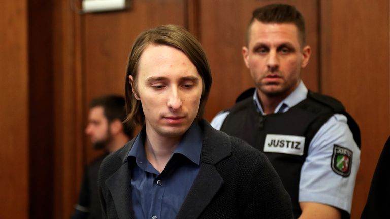 Defendant Sergej W., 28, is escorted by a judicial officer into district court as he arrives for trial on 28 charges of attempted murder, Dortmund, Germany