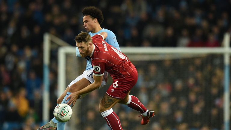 Leroy Sane vies with Nathan Baker during the Carabao Cup semi-final first leg between Manchester City and Bristol City
