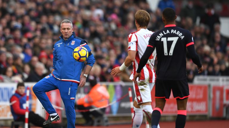 Paul Lambert, Manager of Stoke City passes ball to the players during the Premier League match between Stoke City and Huddersfield