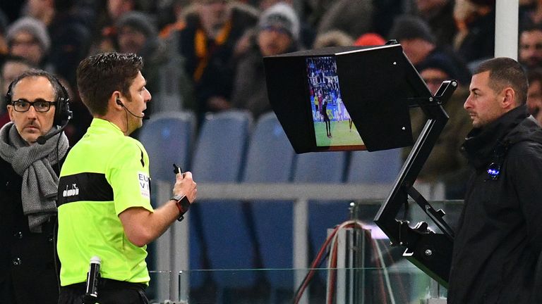 Referee Gianluca Rocchi checks the Video assistant referee (VAR) during the Italian Serie A football match AS Roma vs Lazio on November 18, 2017 at the Oly
