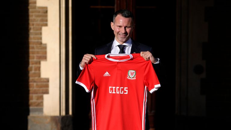 Ryan Giggs poses with a Wales shirt after being unveiled as new manager of the national team