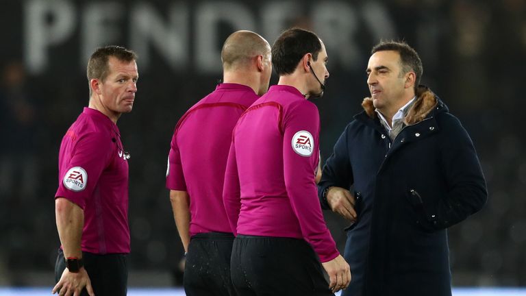 Carlos Carvalhal protests with referee Bobby Madley and the two assistants after the full-time whistle