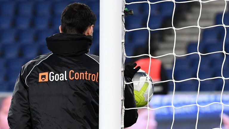 A man from the German company GoalControl checks the operation of the goal-line technology before the French L1 football match between Paris Saint-Germain 