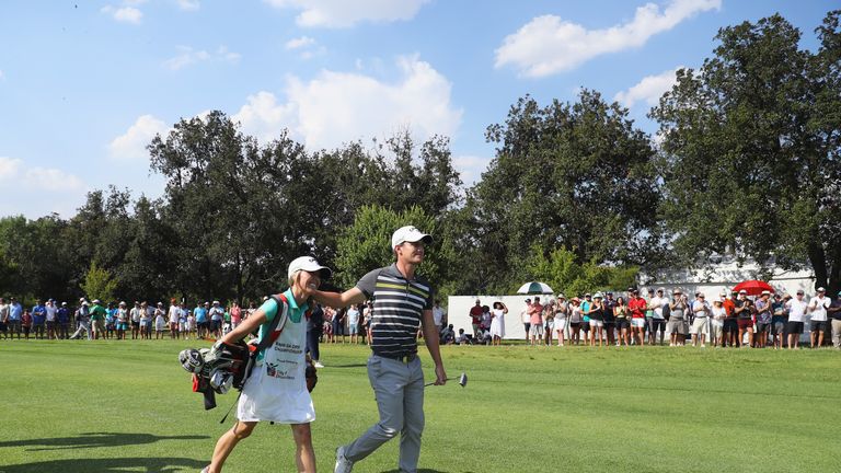 JOHANNESBURG, SOUTH AFRICA - JANUARY 14:  Chris Paisley of England walks to the 18th green with caddie and wife Keri on the way to victory during day four 