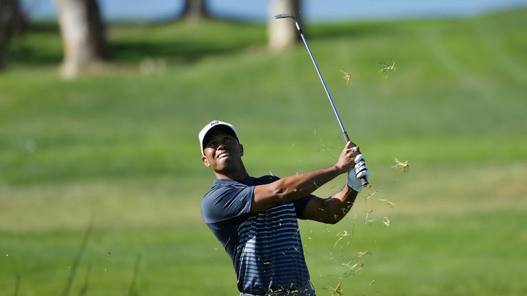 Tiger Woods plays a shot from the rough on the 13th hole during the second round of the Farmers Insurance Open at Torrey Pines