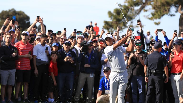 SAN DIEGO, CA - JANUARY 27:  Tiger Woods plays his second shot from the rough on the 13th hole during the third round of the Farmers Insurance Open at Torr