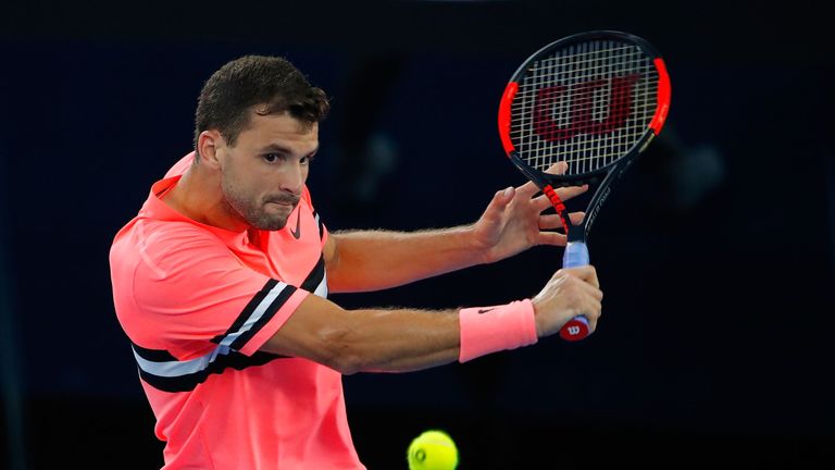 Grigor Dimitrov of Bulgaria plays a backhand in his second round match against Mackenzie McDonald of the United States at the Australian Open