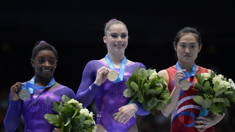 (From L) Silver medalist USA's Simone Biles, gold medalist USA's Mc Kayla Maroney, and bronze medalist Popular Republic of Korea's Un Jong Hong celebrate o