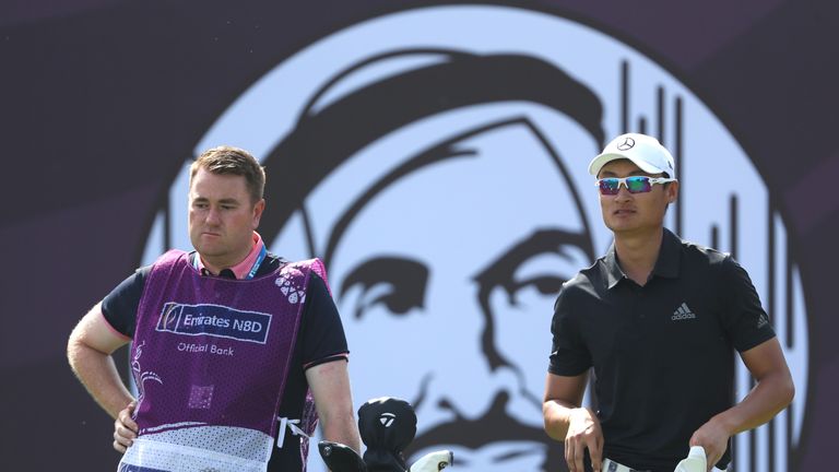 DUBAI, UNITED ARAB EMIRATES - JANUARY 27:  Haotong Li of China and his caddie look on from the 2nd tee during day three of Omega Dubai Desert Classic at Em