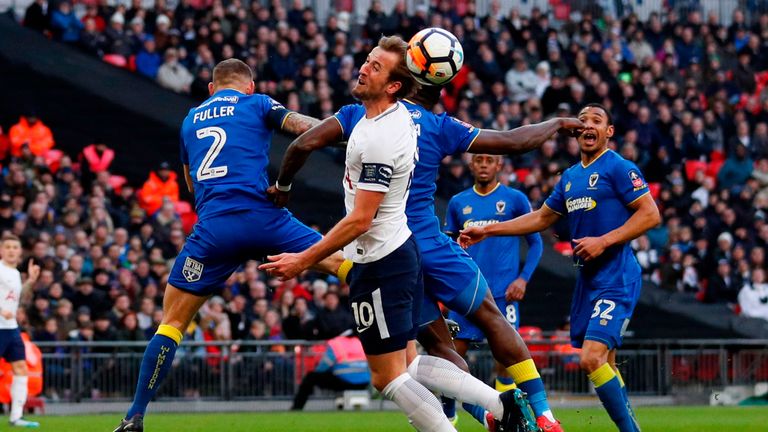 Tottenham Hotspur's Harry Kane (C) mis-times a header in front of goal during the English FA Cup third round football match v AFC Wimbledon