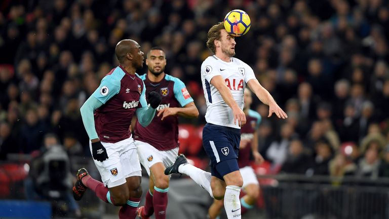 LONDON, ENGLAND - JANUARY 04:  Harry Kane of Tottenham Hotspur controls the ball under pressure from Angelo Ogbonna of West Ham United during the Premier L