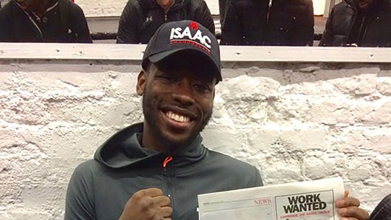 Isaac Chamberlain poses with an advert he placed in Lawrence Okolie's local newspaper ahead of their cruiserweight clash