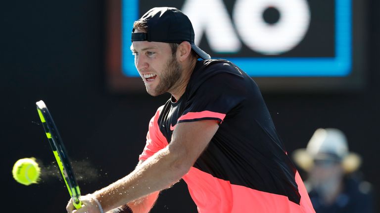 Jack Sock of the United States plays a backhand in his first-round match against Yuichi Sugita of Japan 