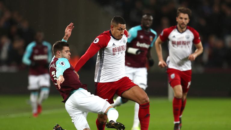 LONDON, ENGLAND - JANUARY 02: Aaron Cresswell of West Ham United tackles Jake Livermore of West Bromwich Albion during the Premier League match between Wes