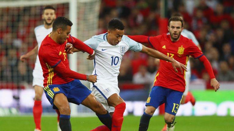 Jesse Lingard takes on Thiago Alcantra and Juan Mata during the international friendly match between England and Spain at Wembley Stadium