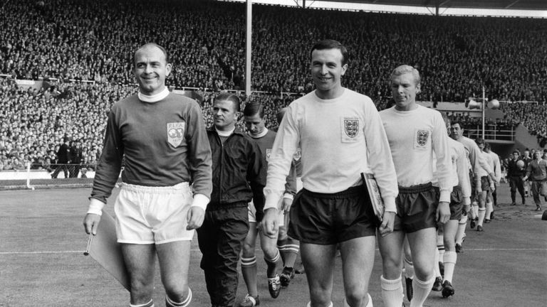 Leeds United footballer Jimmy Armfield (right) leads out the England team as captain, as Alfredo Di Stefano leads out the Rest Of The World Team. They are 