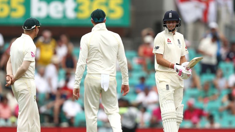 SYDNEY, AUSTRALIA - JANUARY 08: Joe Root of England speaks with Steve Smith and David Warner of Australia  during day five of the Fifth Test match in the 2